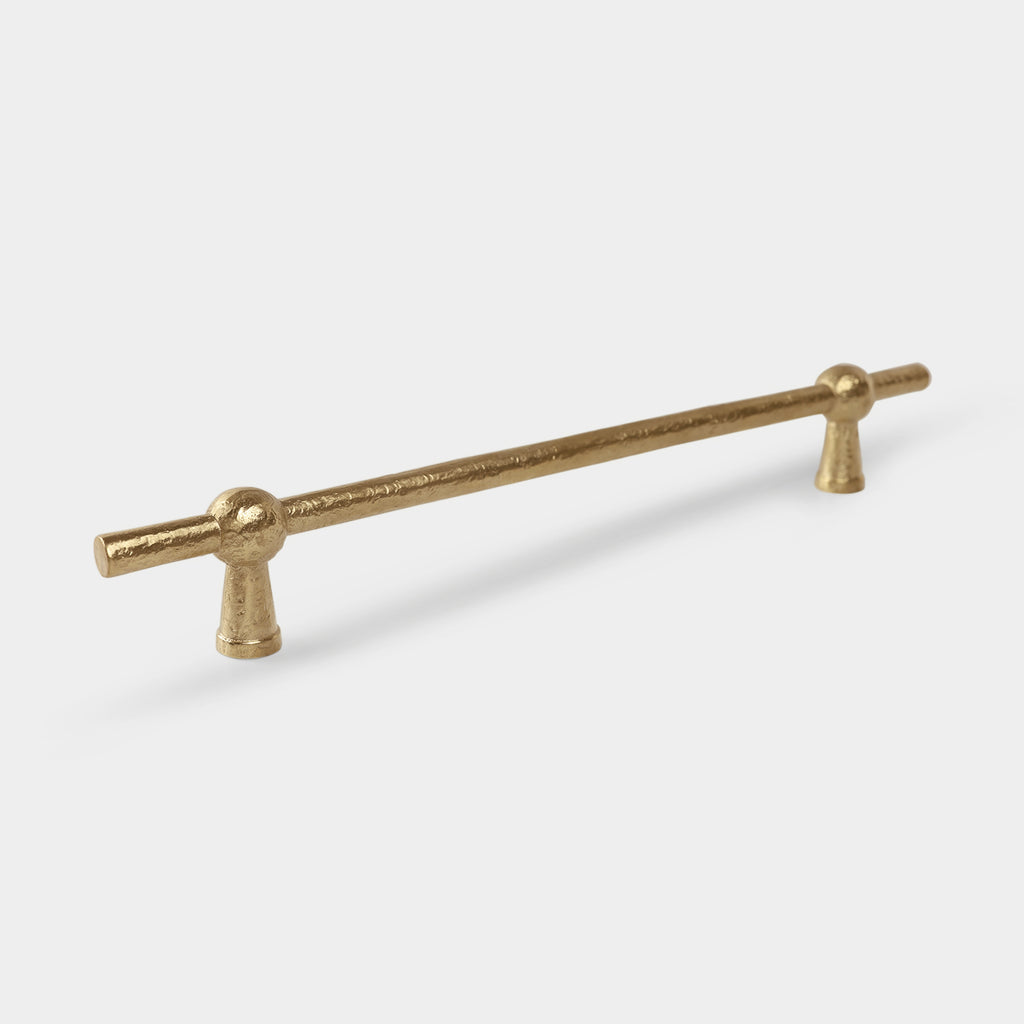 Brass Dunand pull bar with a sleek and elegant design