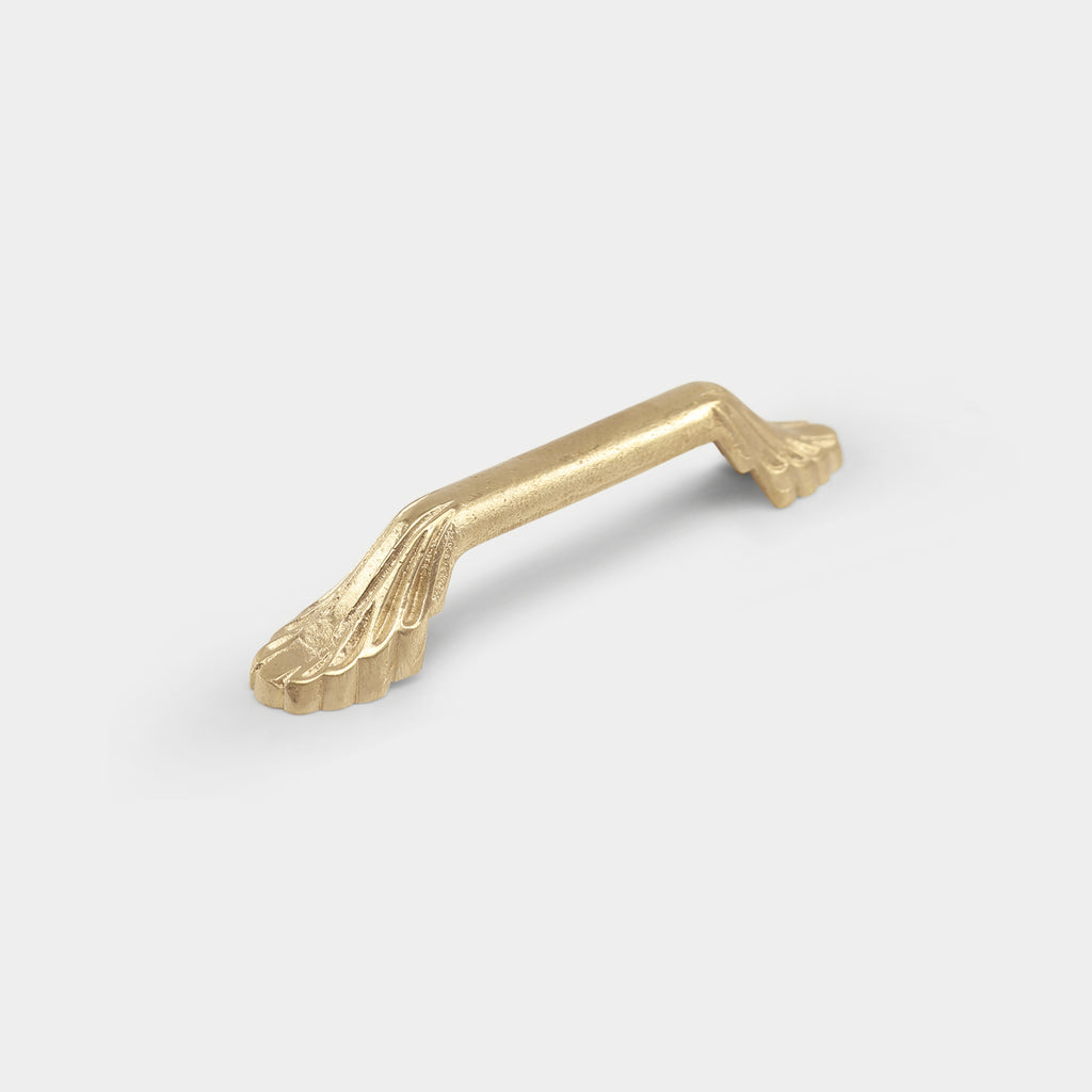 Small brass Guimard pull handle with intricate, elegant detailing.